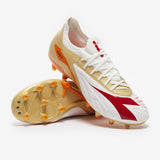 Tacos de fútbol Diadora Maximus Elite Pro SLX FG para terreno firme - Blanco/Chili Pepper/Naranja Russet
