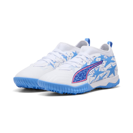 Tacos de fútbol PUMA Ultra 6 Match KidSuper X CP + Mid TT Turf para jóvenes - Blanco/Rosa/Azul