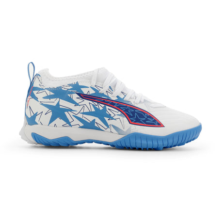 Tacos de fútbol PUMA Ultra 6 Match KidSuper X CP + Mid TT Turf para jóvenes - Blanco/Rosa/Azul