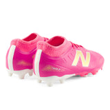 Tacos de fútbol juvenil New Balance Tekela Team Low V5 FG para terreno firme - Rosa Caliente